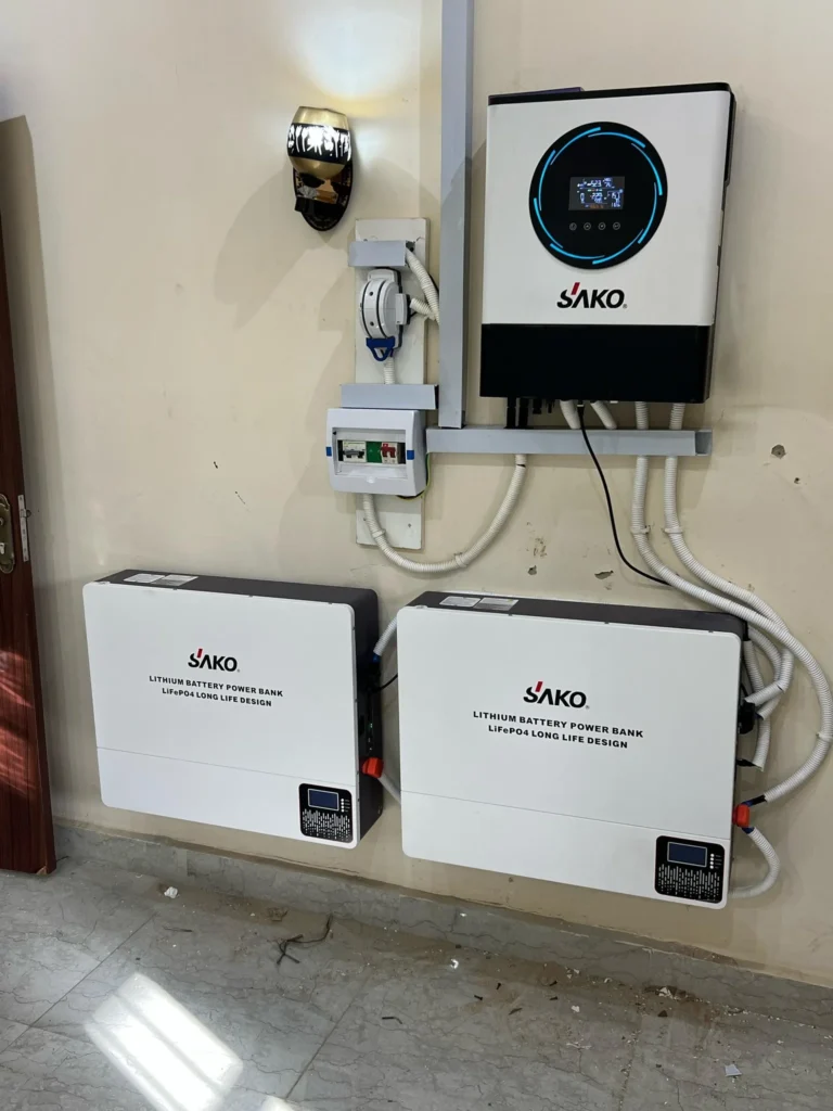 SAKO branded energy storage system with lithium batteries and solar inverter mounted on a wall, showcasing power conversion setup.