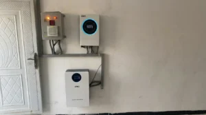 SAKO inverter and energy storage lithium battery installed on a wall in a residential setting, next to a door.