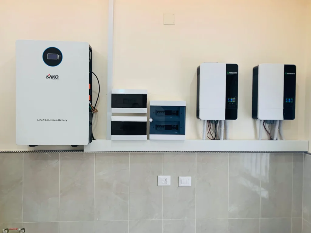SAKO LiFePO4 lithium battery and Growatt solar inverters mounted on a wall, part of an energy storage system.